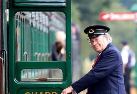 Picture of a conductor next to a train at the Isle of Wight Railway.